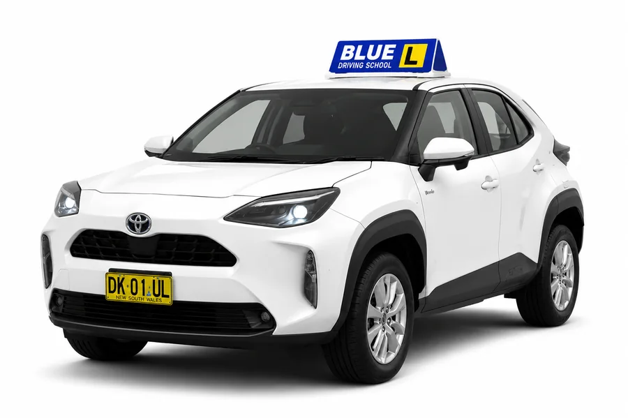 Blue Driving School's white Toyota Yaris Cross Hybrid with roof sign